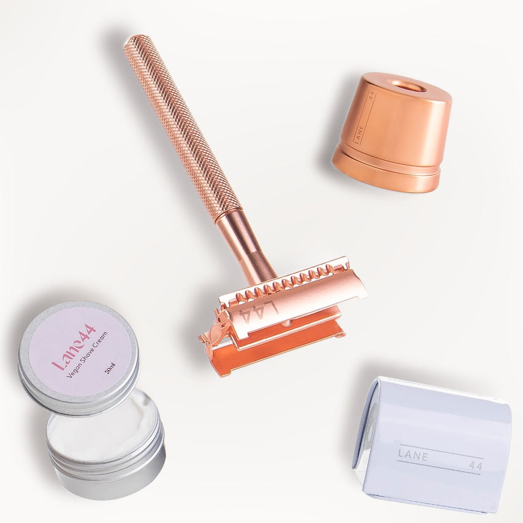 rose gold safety razor open with stand, double edge razor blade recycling bin and natural shaving cream