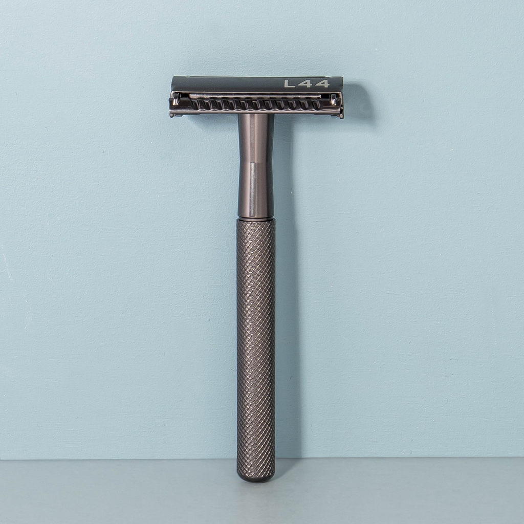 black safety razor against wall