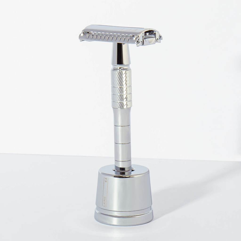 silver safety razor in shaving stand