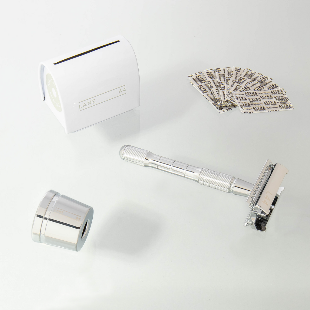 silver safety razor with blade recycling bin and accessories
